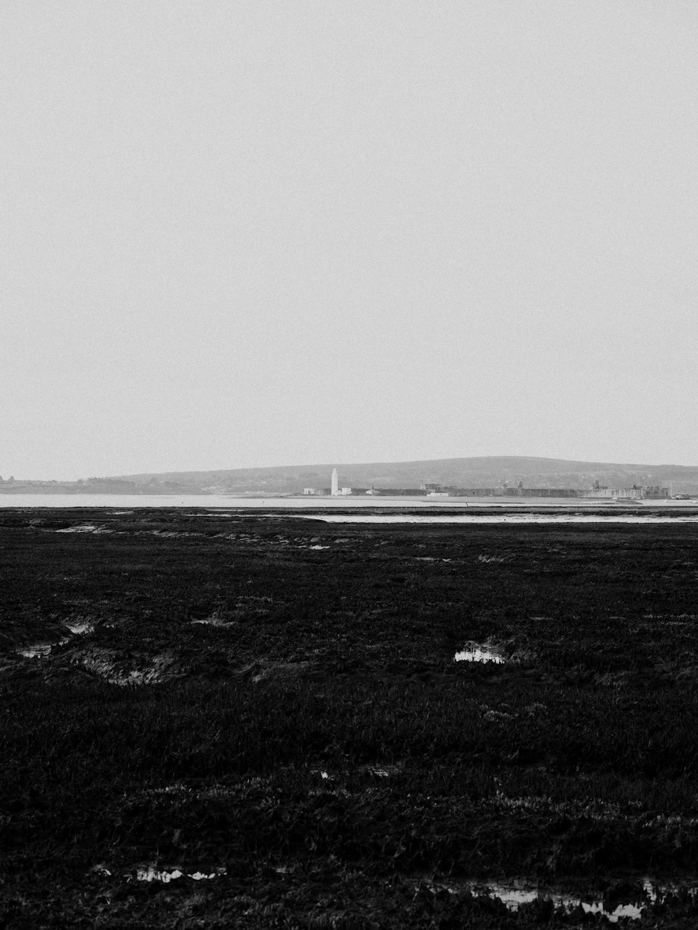 a black and white photo of a plane in the sky