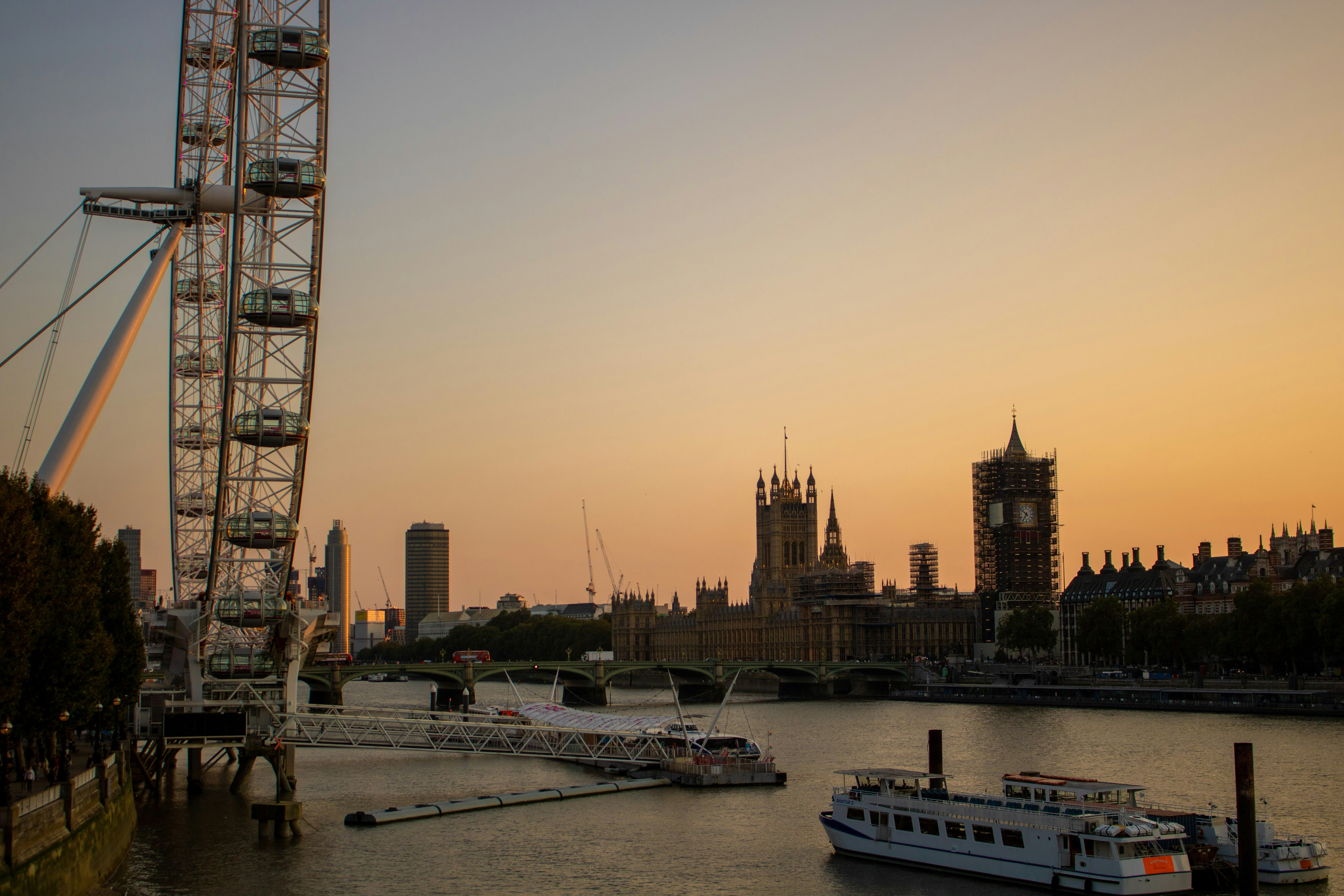 A large ferris wheel sitting next to a body of water