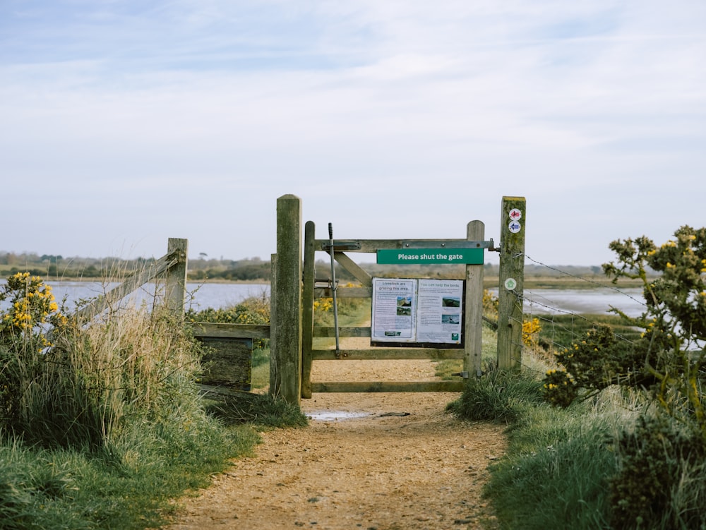 a wooden gate with a sign on it