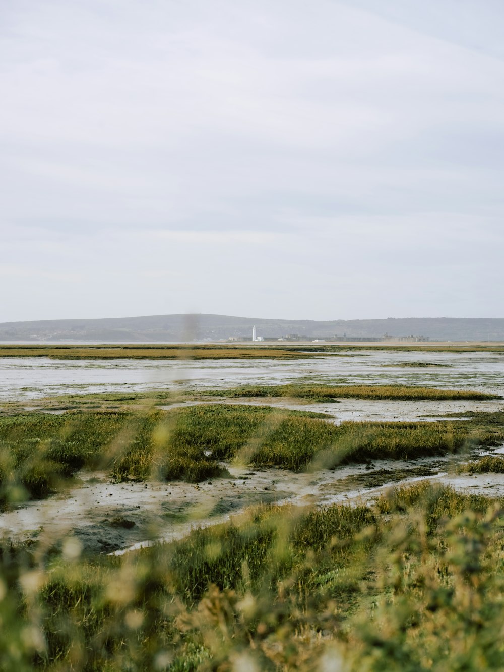 a view of a body of water through a fence