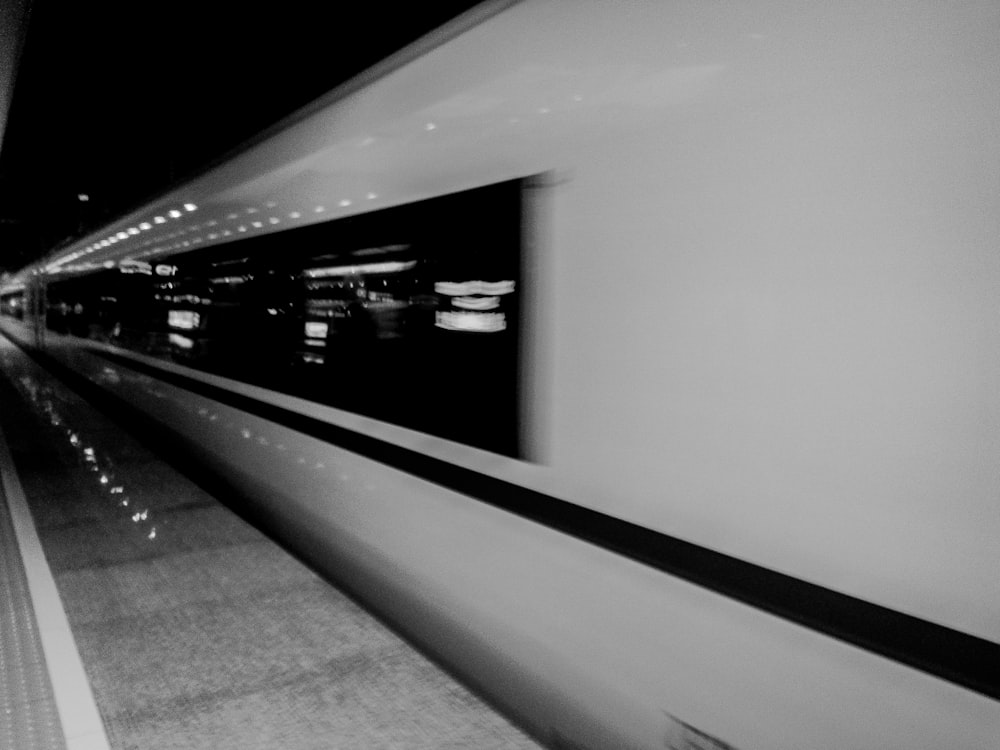 a black and white photo of a train at night