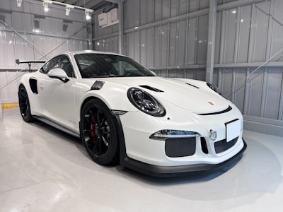 a white sports car parked in a garage