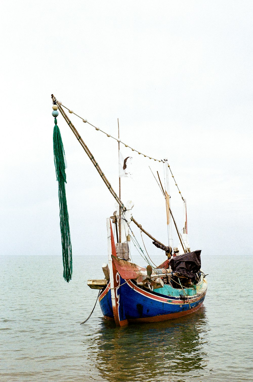 a small boat floating on top of a body of water