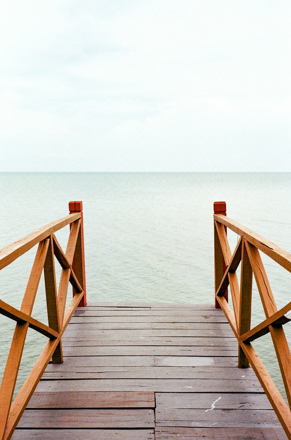 a wooden dock extending into the ocean