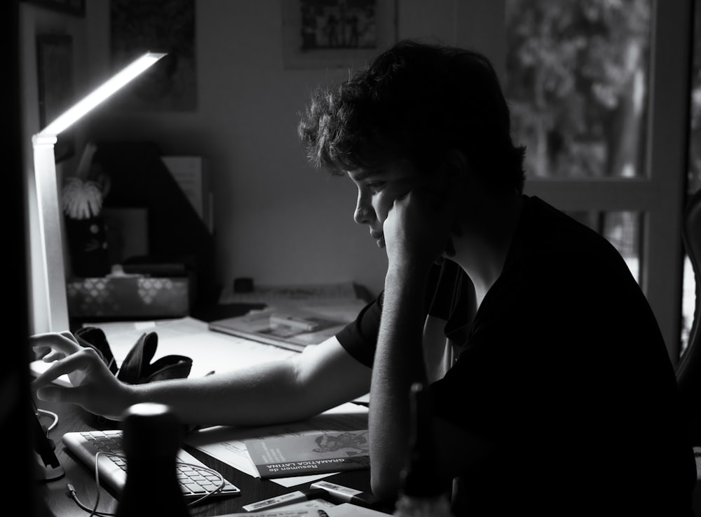 a man sitting at a desk in front of a computer