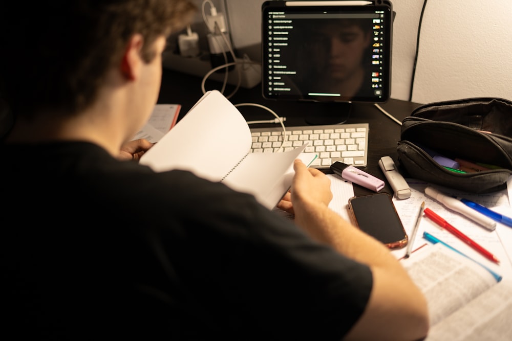 a man sitting in front of a laptop computer