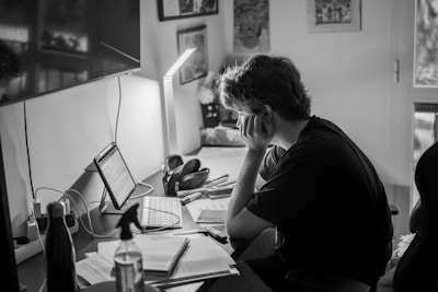 a person sitting at a desk with a laptop