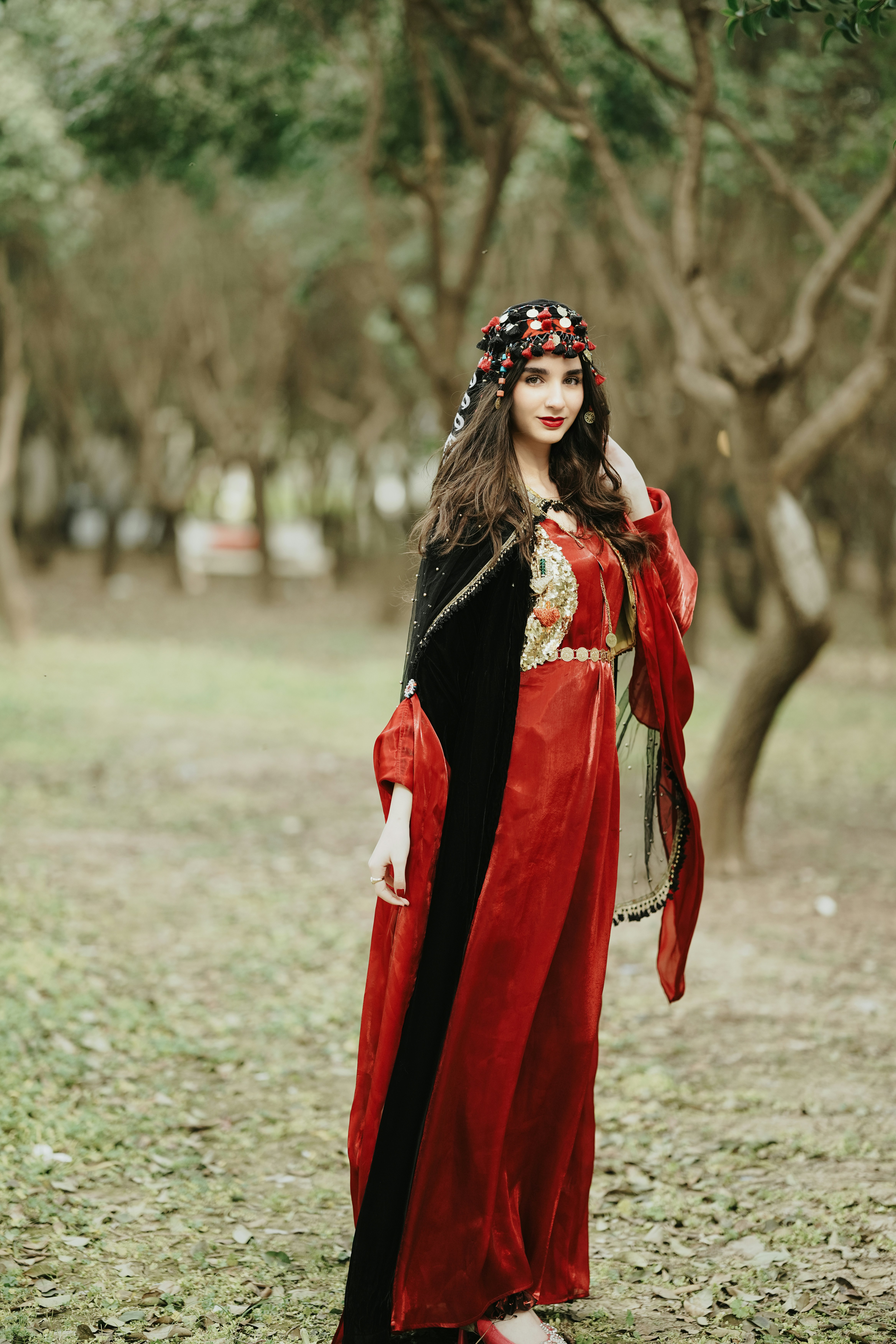 a woman in a red dress standing in a field