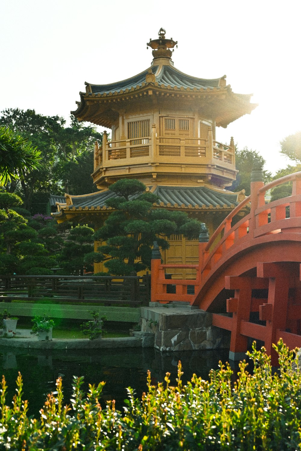 a yellow and red building with a bridge in front of it