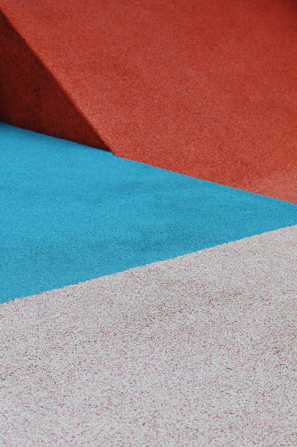 a skateboard sitting on top of a blue and red ramp