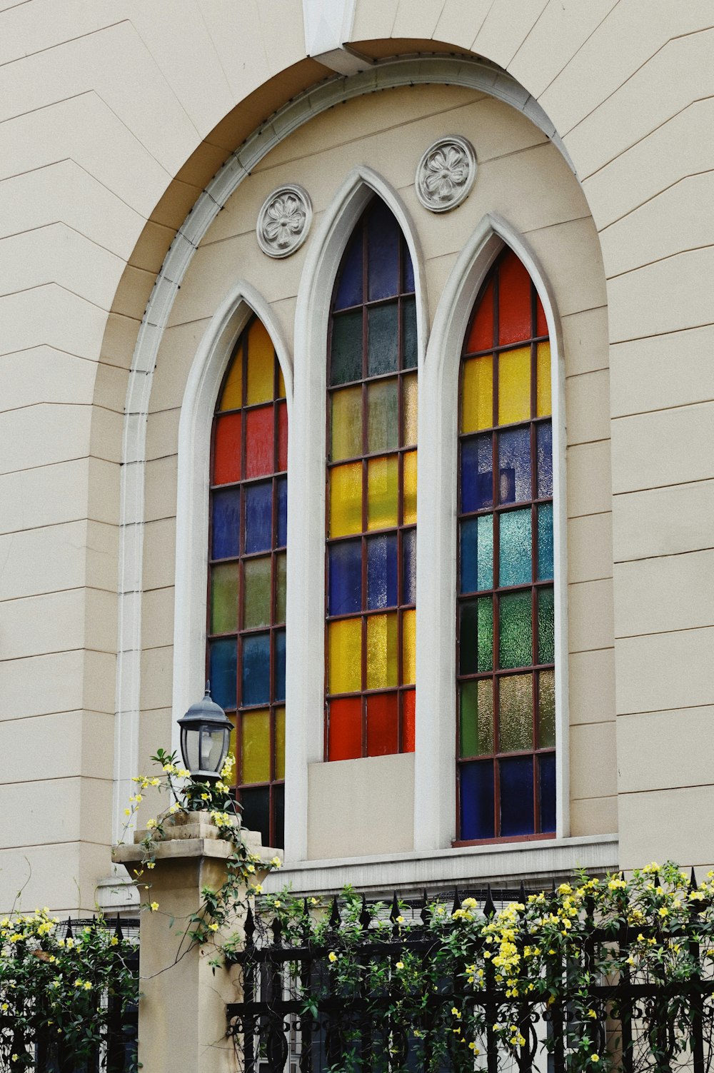 a stained glass window on the side of a building