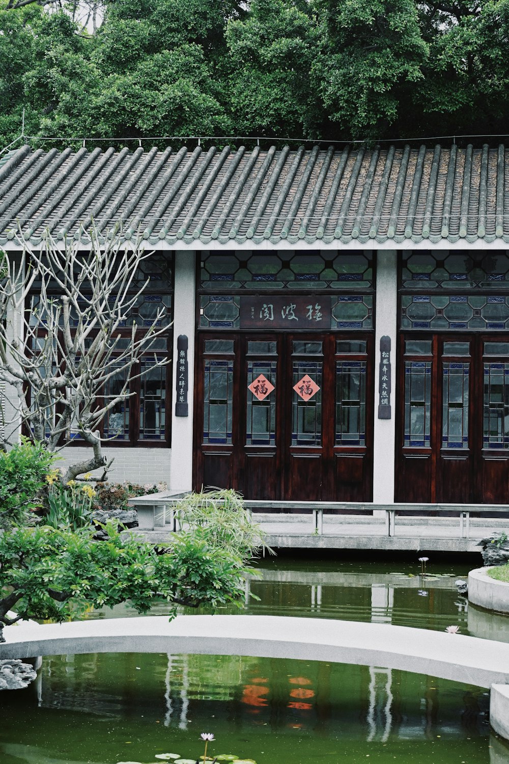 a building with a pond in front of it