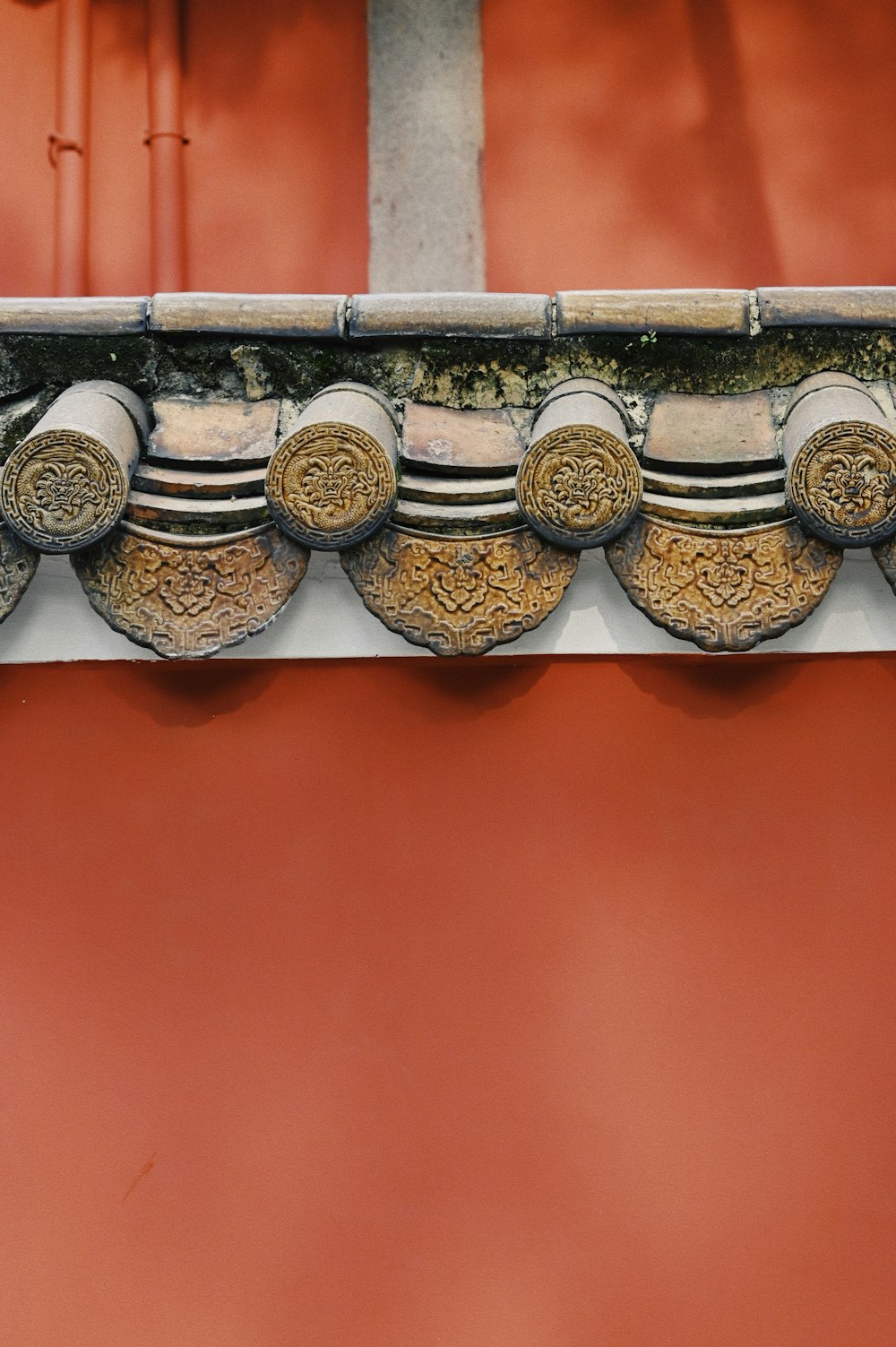 a close up of a building with a red wall