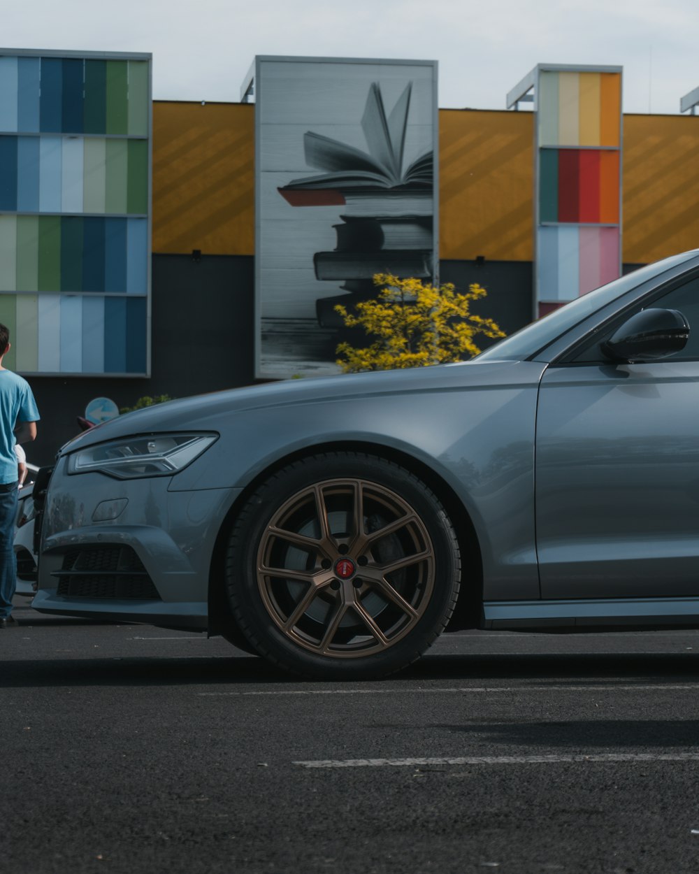 a grey car parked in front of a building