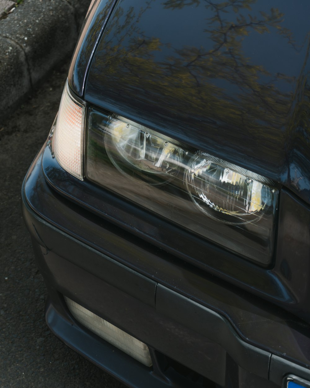 a close up of a car headlight on a street
