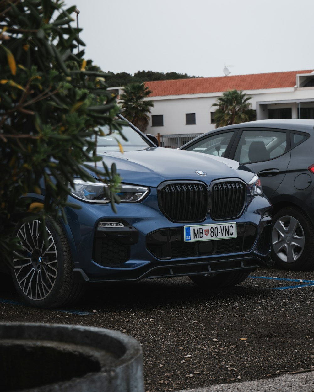 two cars parked next to each other in a parking lot