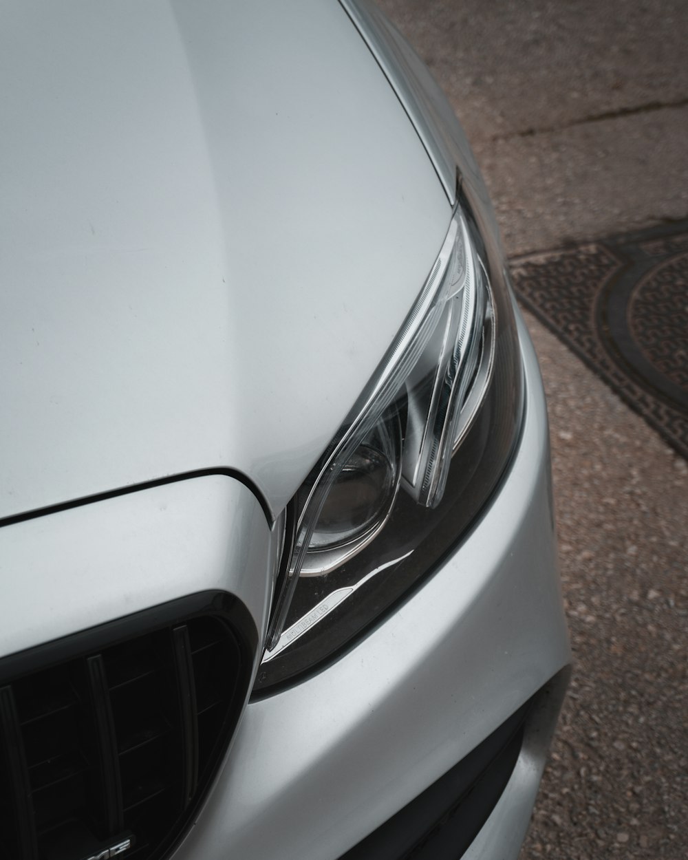 a close up of the front of a silver car