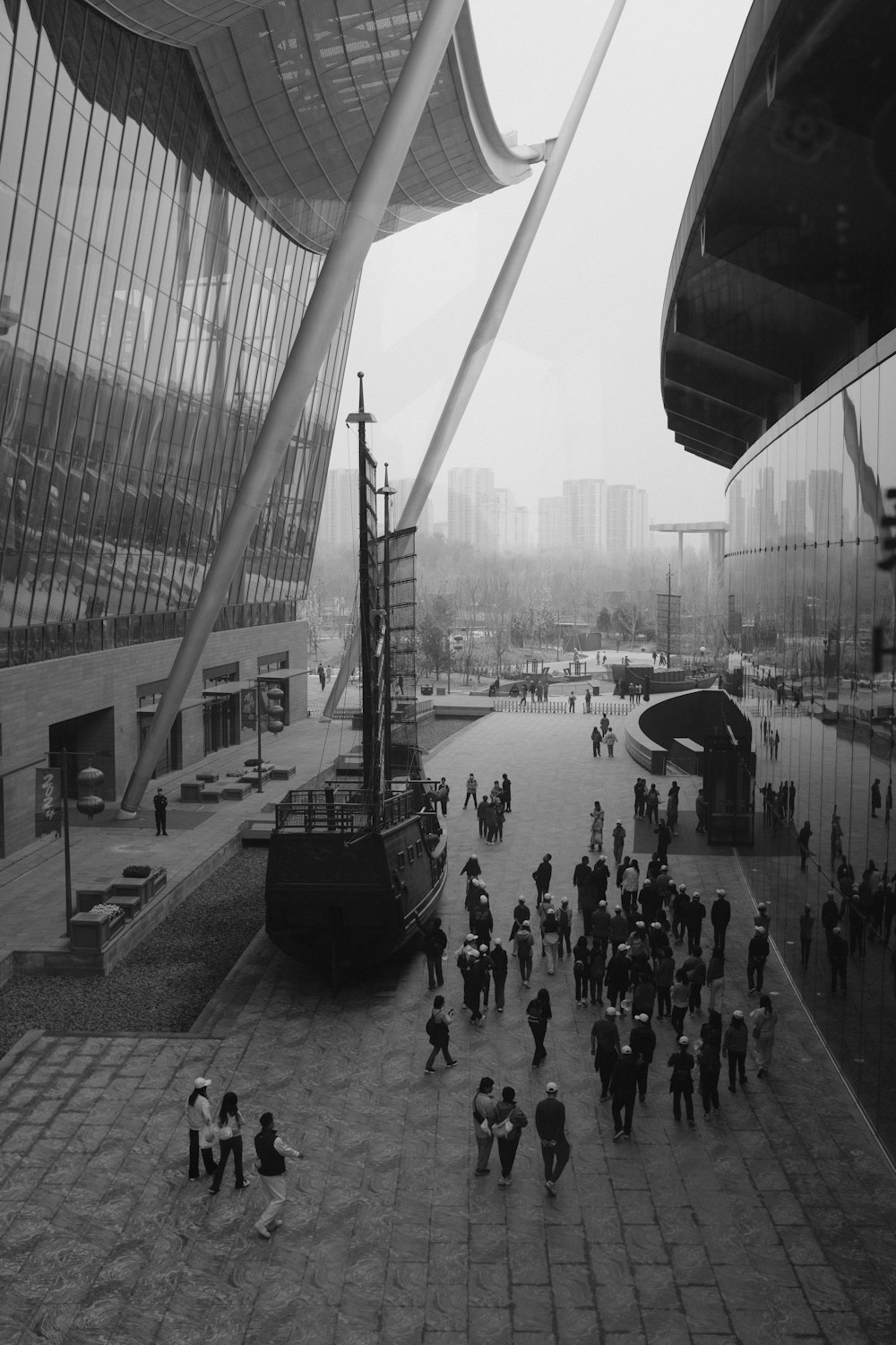 a black and white photo of people walking around