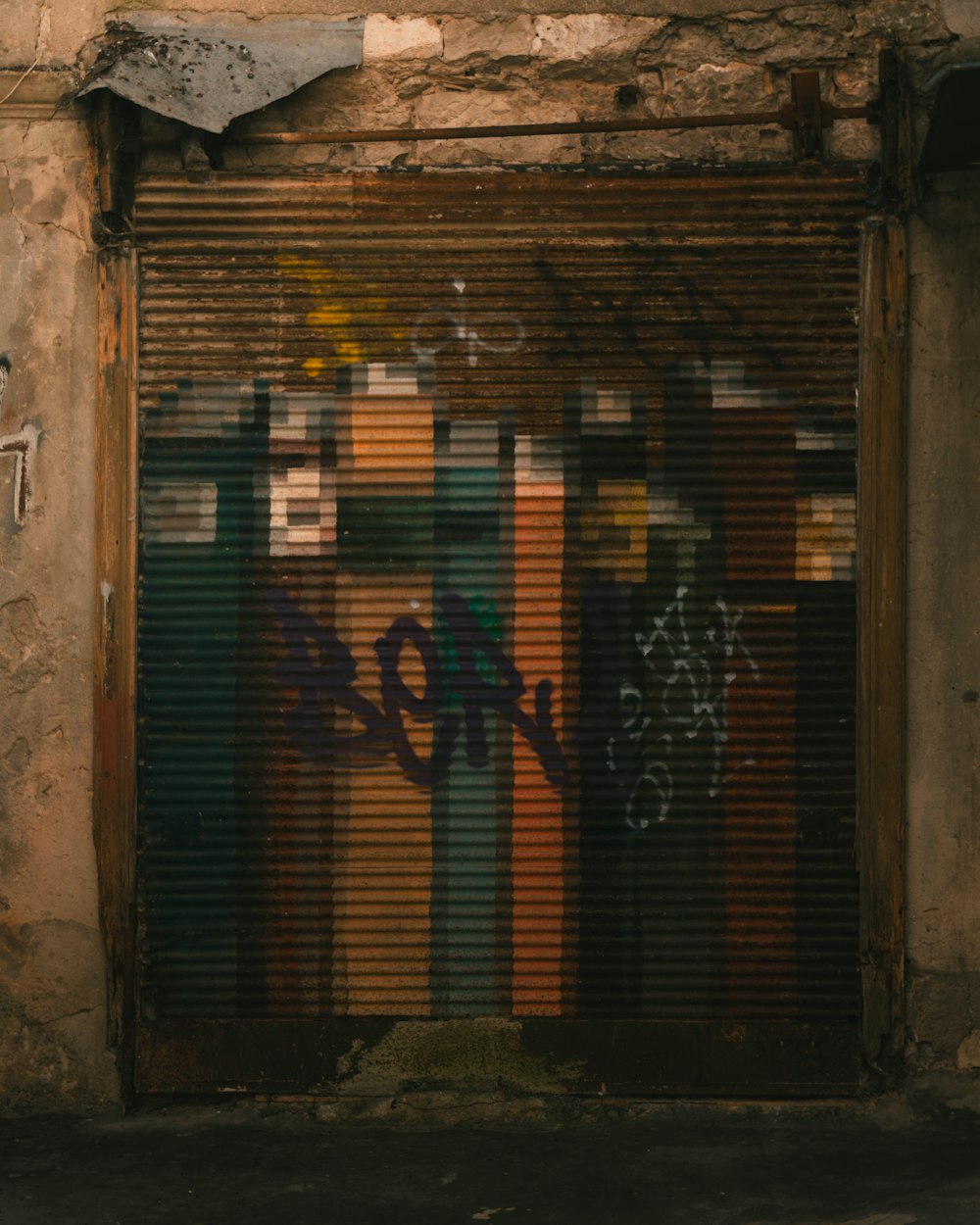 a closed garage door with graffiti on it
