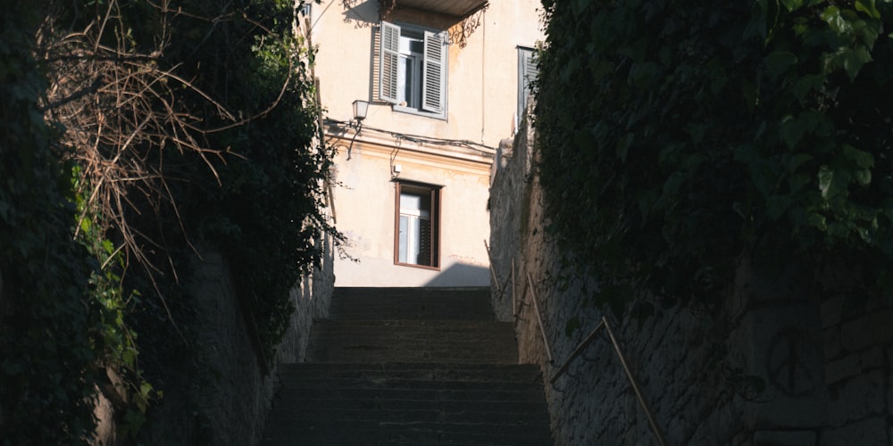 a staircase leading up to a building with a clock on it