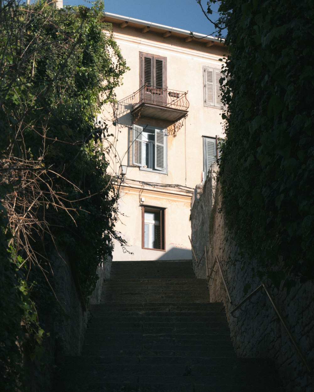 a staircase leading up to a building with a balcony