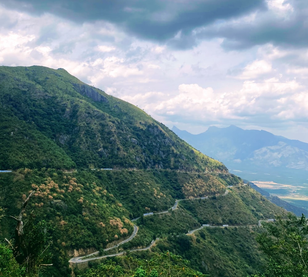 a scenic view of a winding road in the mountains