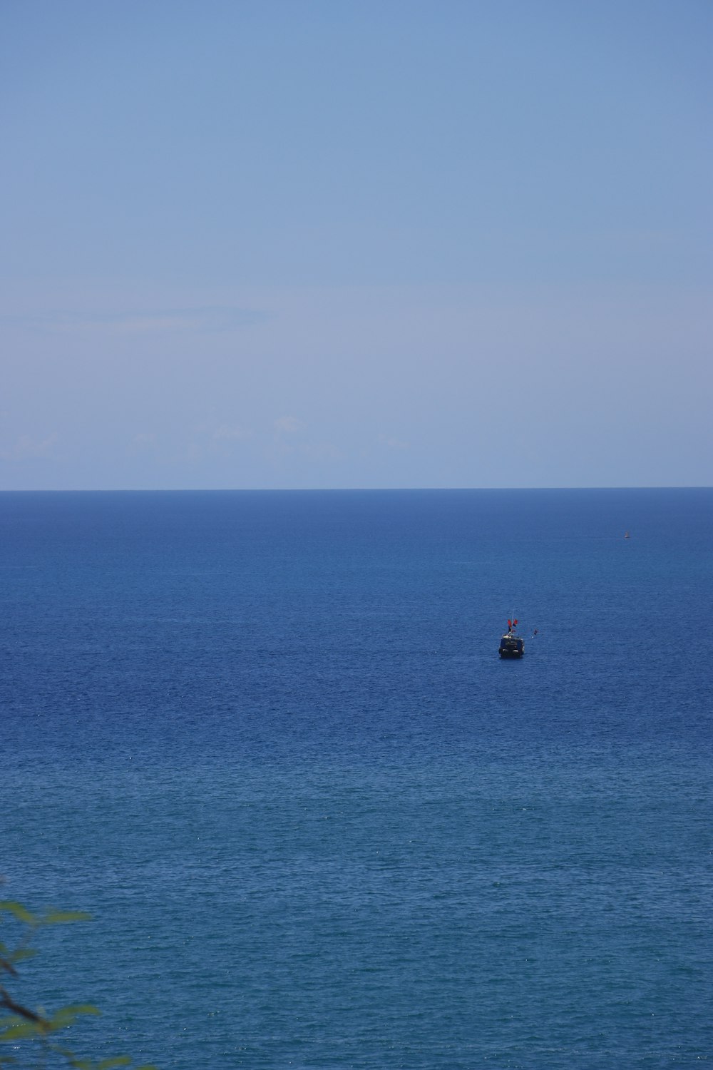 a small boat in the middle of a large body of water