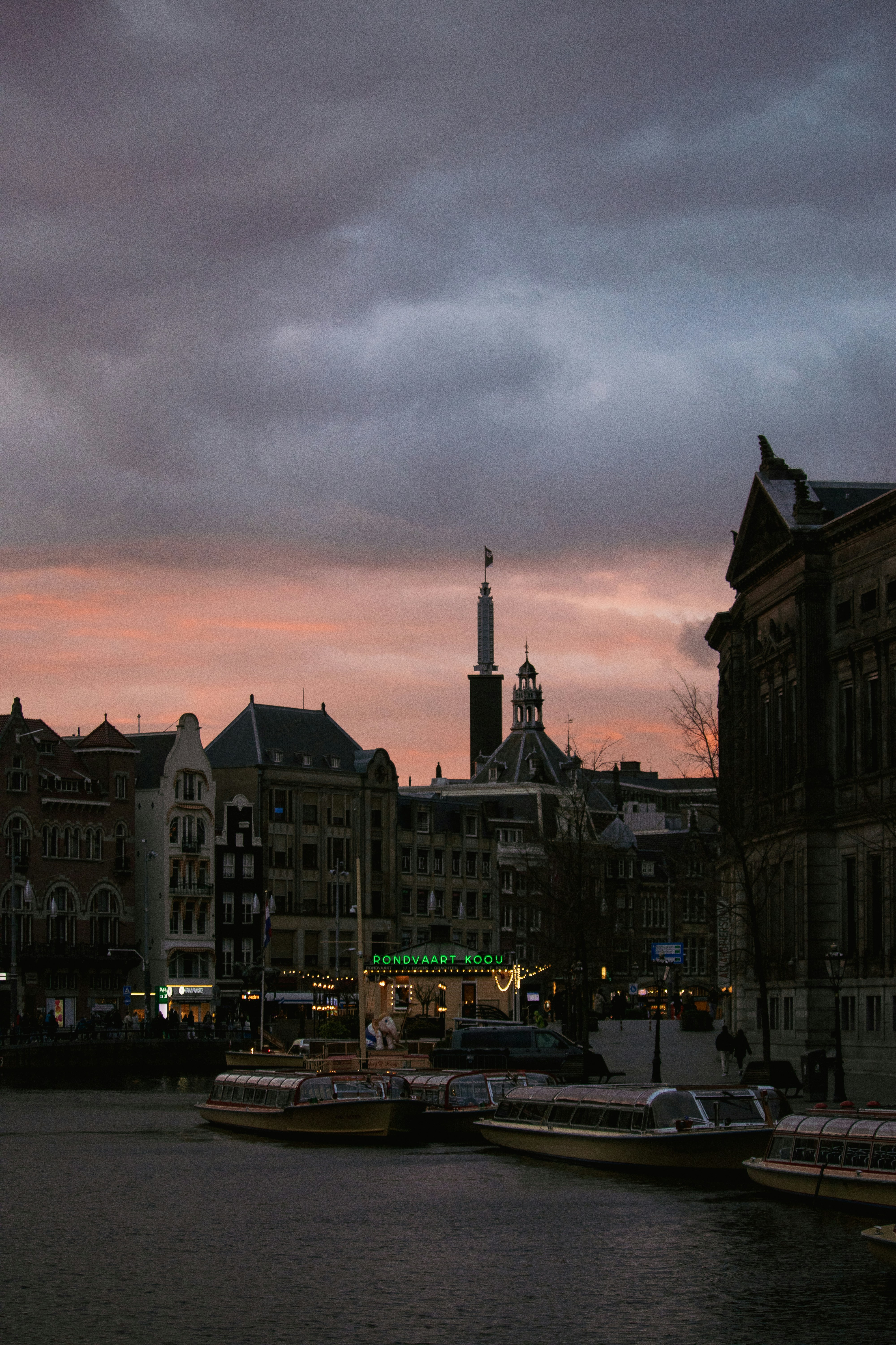 a view of a river with boats and buildings in the background