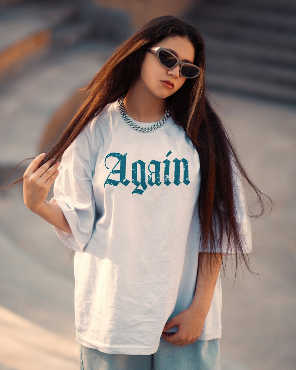 a woman with long hair wearing sunglasses and a t - shirt