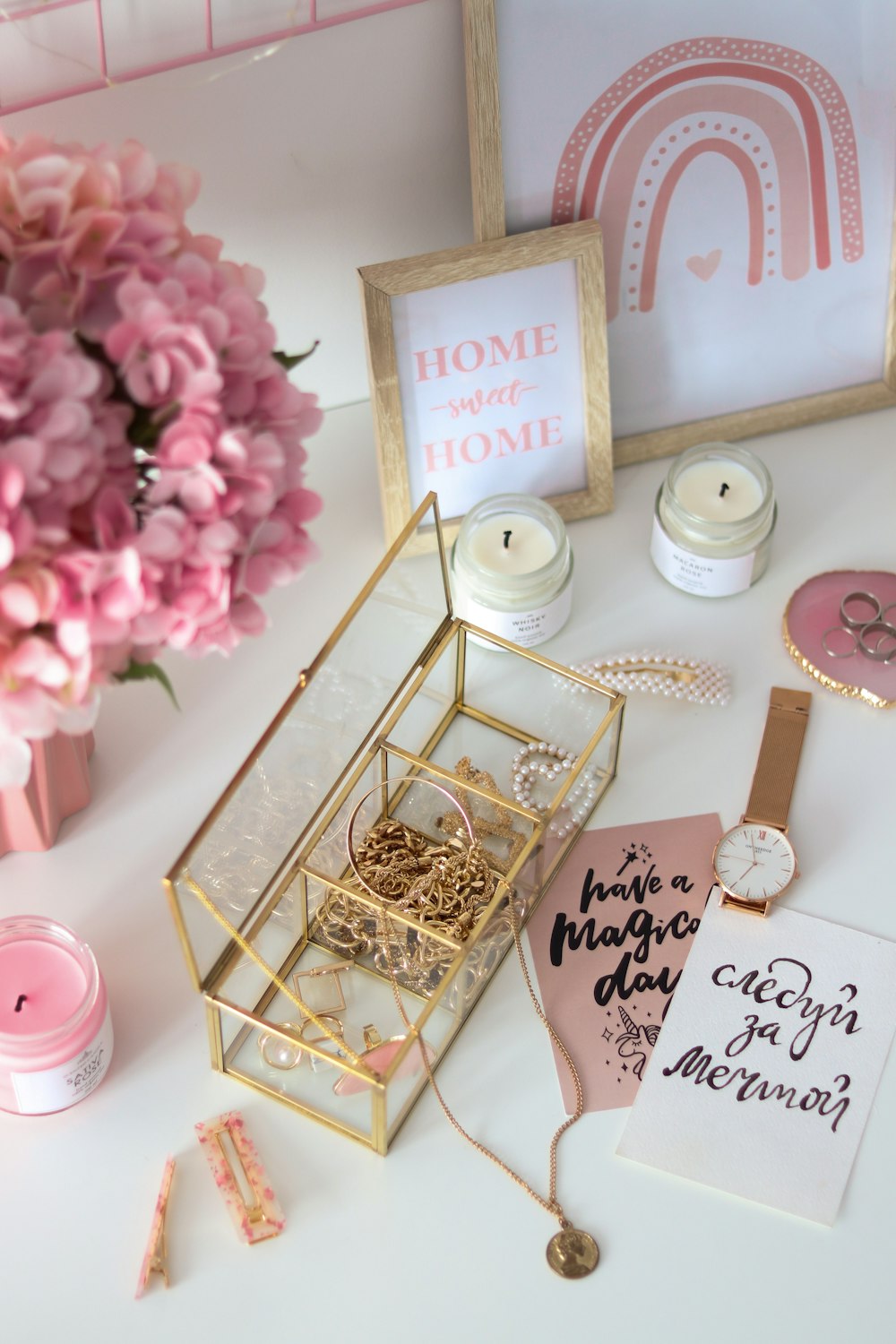 a table topped with a vase filled with pink flowers