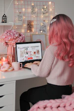 a woman sitting at a desk with a laptop