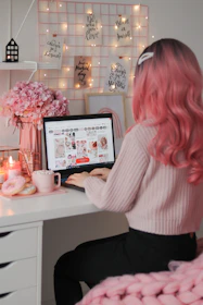 a woman sitting at a desk with a laptop