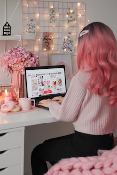 a woman sitting at a desk with a laptop