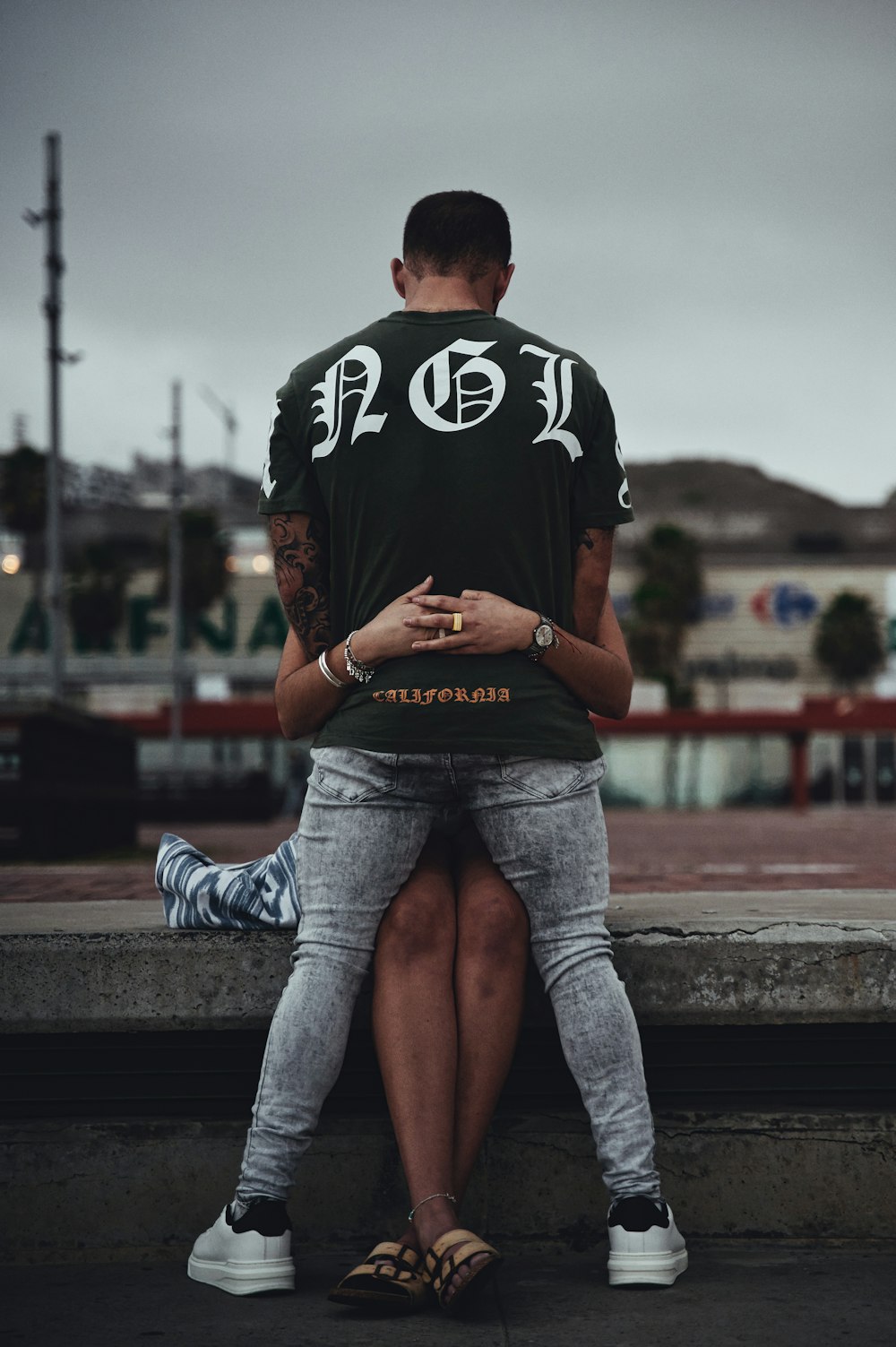 a man and a woman sitting on a ledge