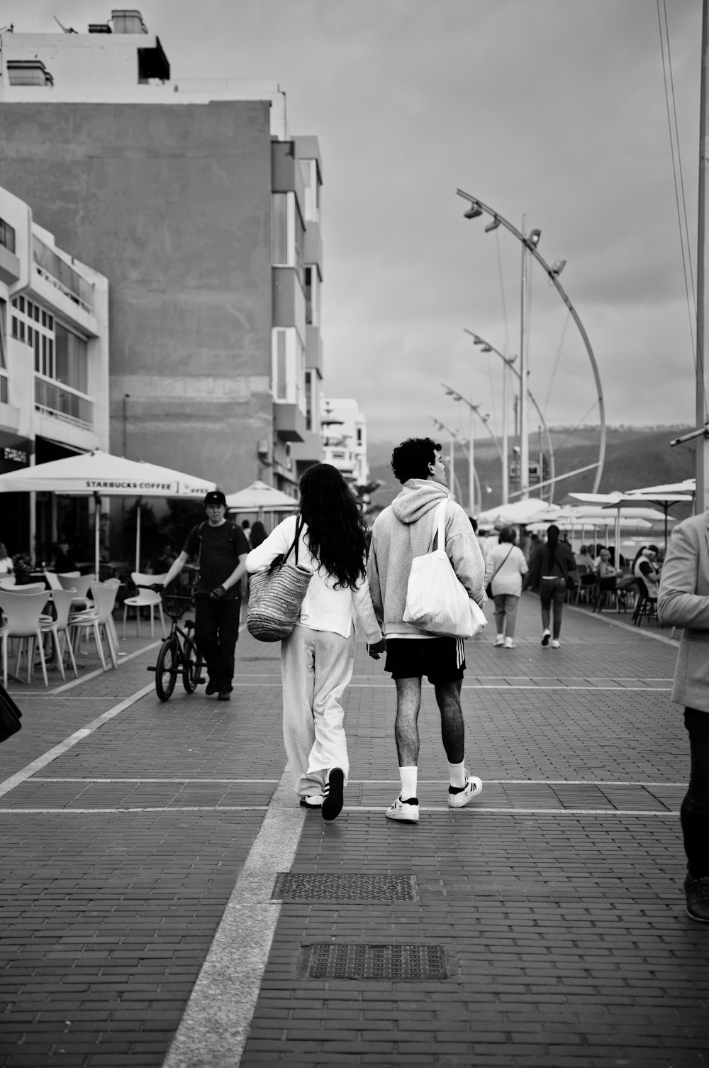 a couple of people walking down a street