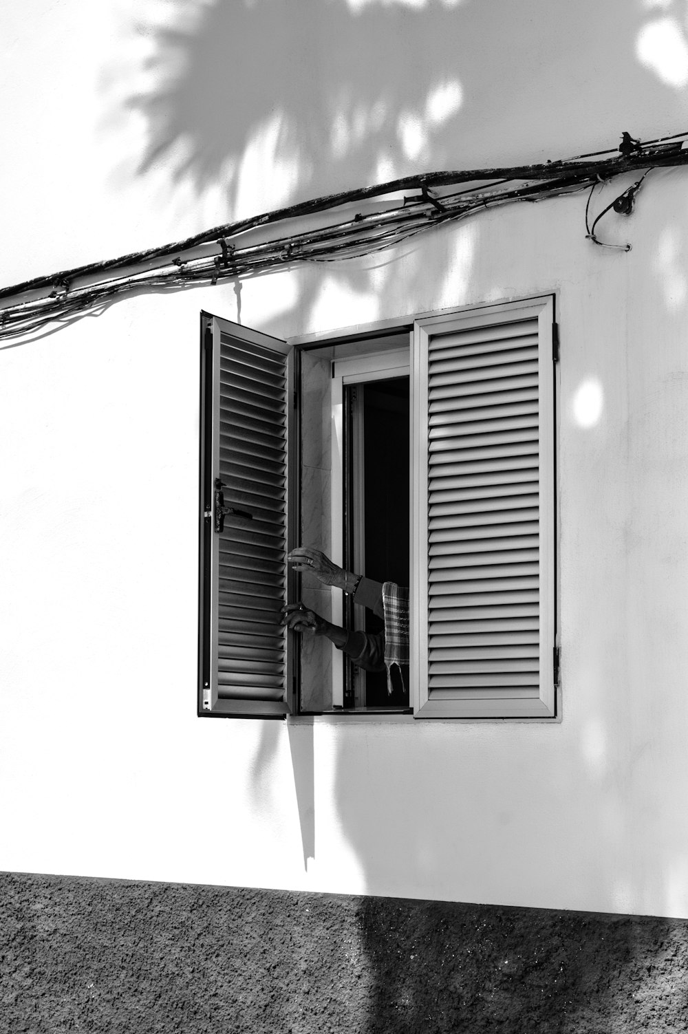 a black and white photo of an open window