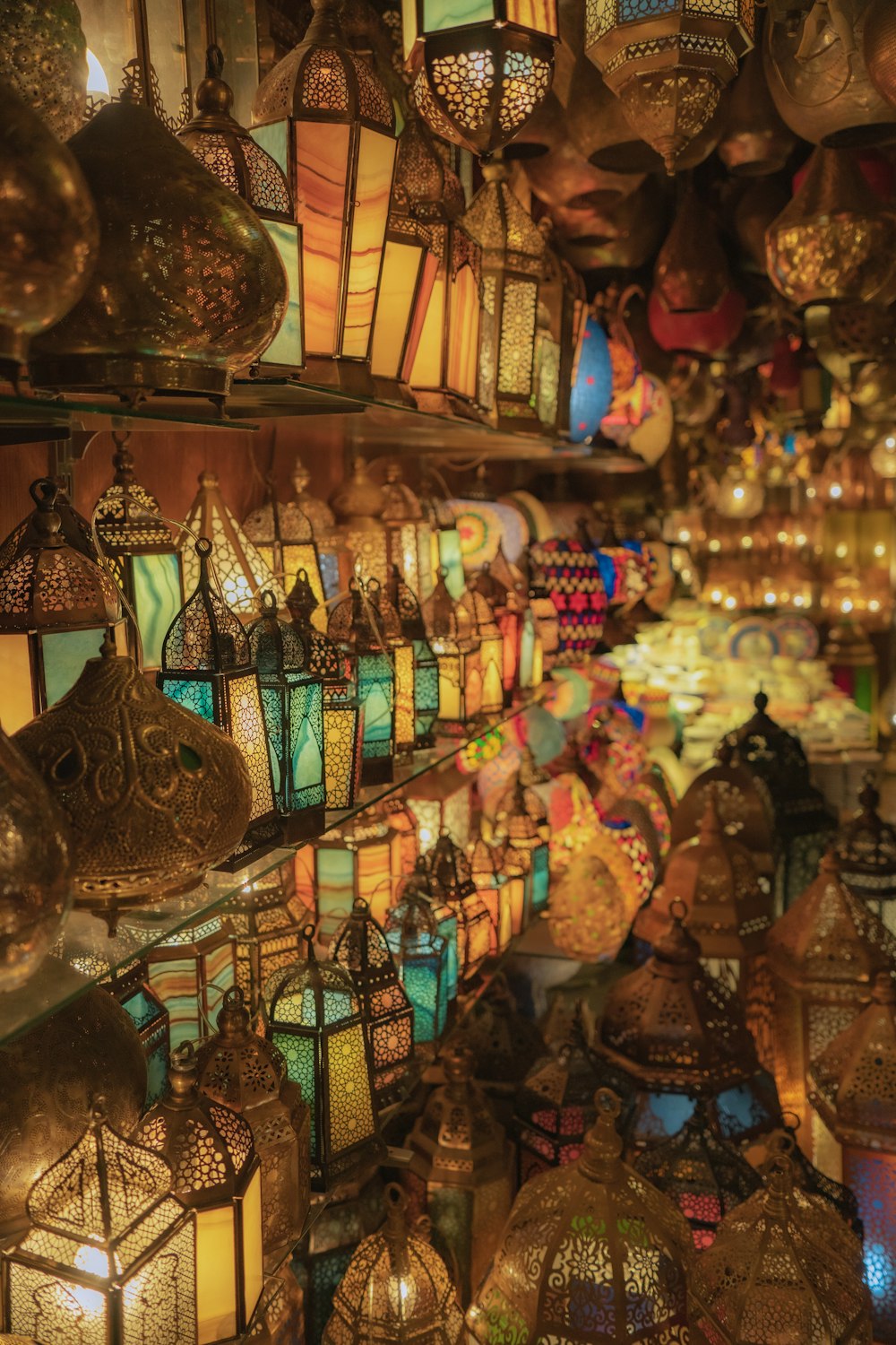 a store filled with lots of lit up lanterns