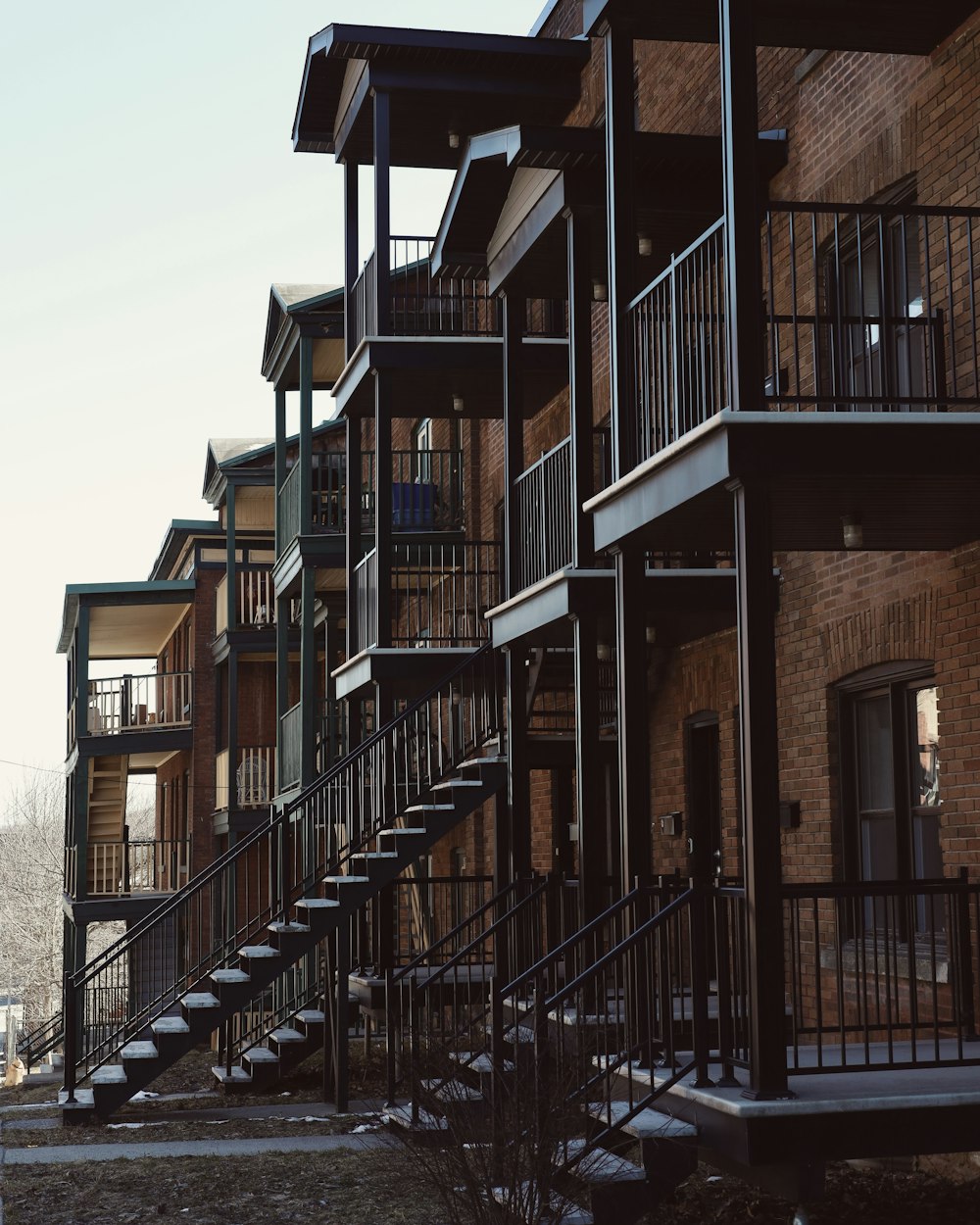 a row of apartment buildings with stairs leading up to them