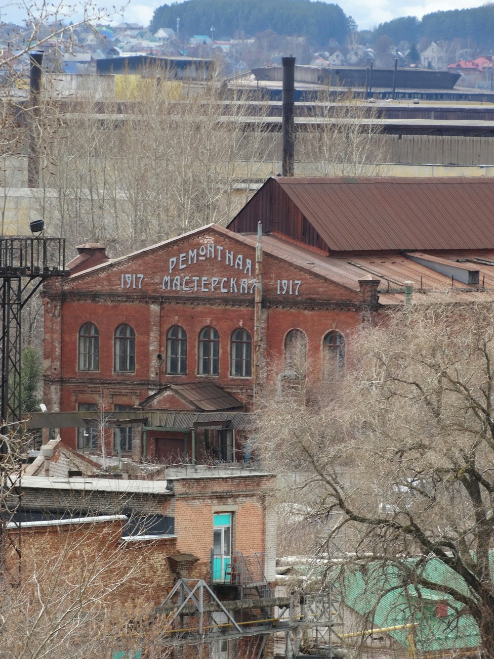 an old factory building with a train in the background