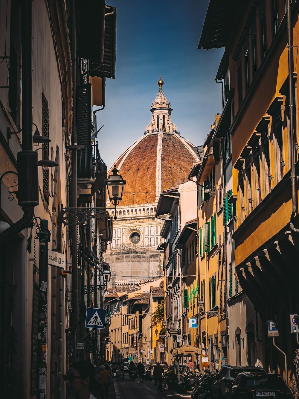 a view of a city street with a dome in the background