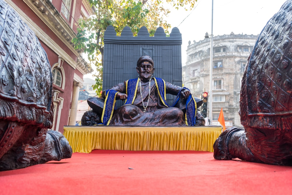 a statue of a man sitting on top of a table