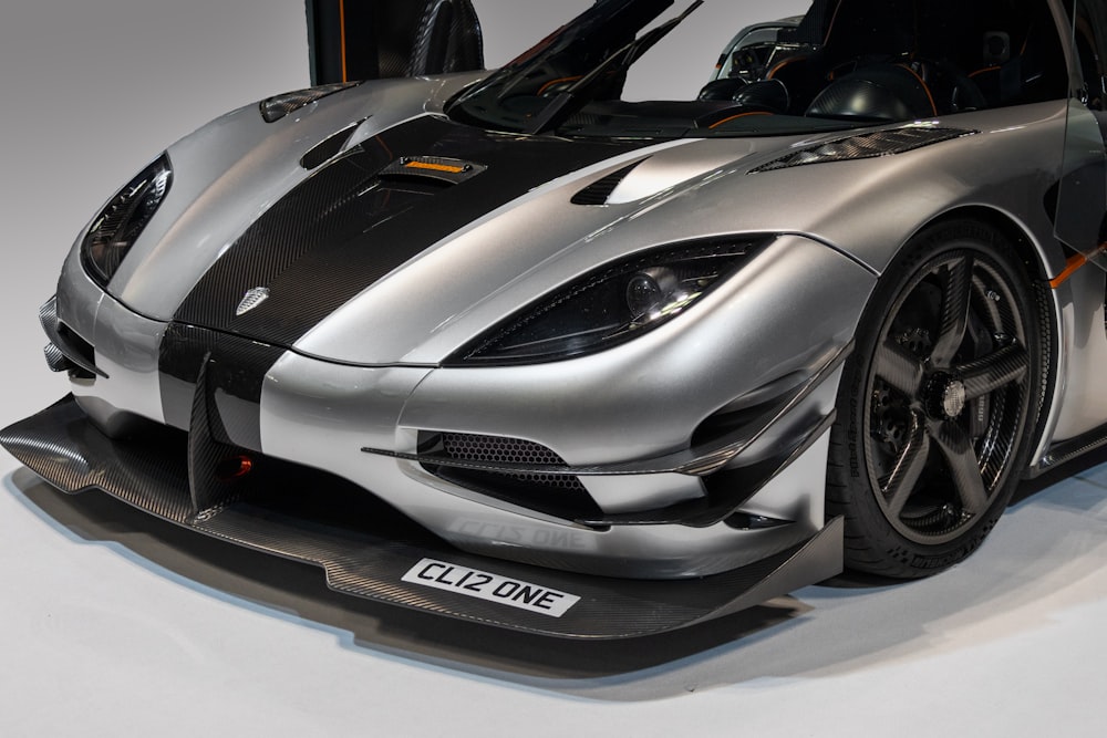 a silver and black sports car on display