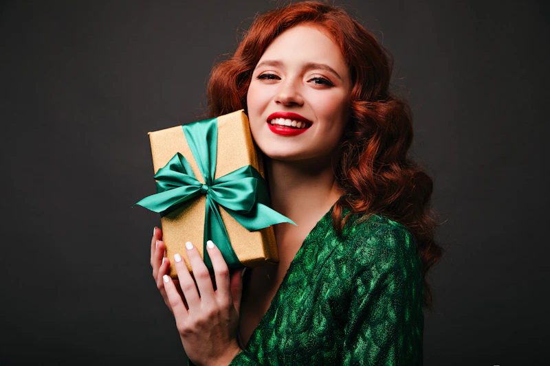 Woman holding a gift box with a green bow