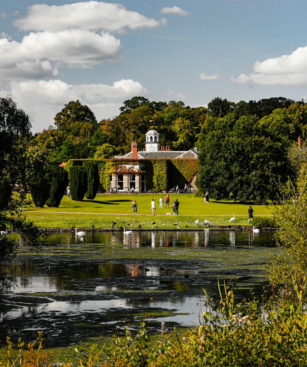 a large house sitting on top of a lush green field