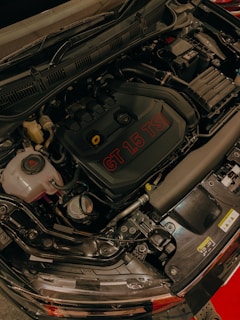 the engine of a car with a red light on it
