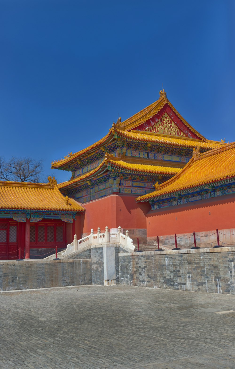 a large building with a yellow roof and red walls