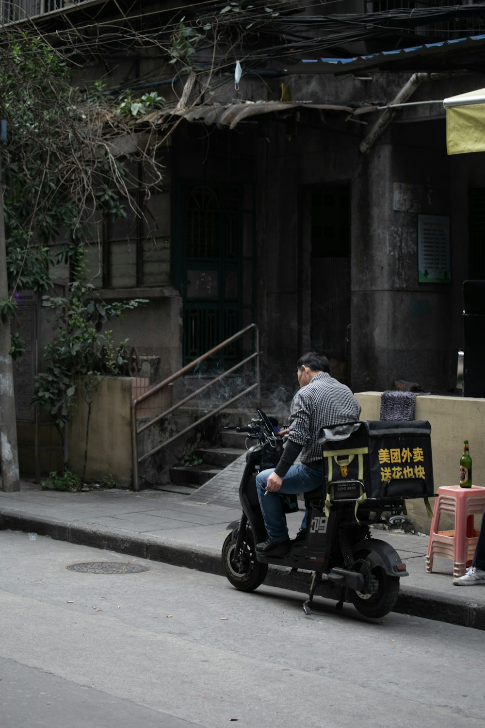 a man sitting on a scooter on a city street