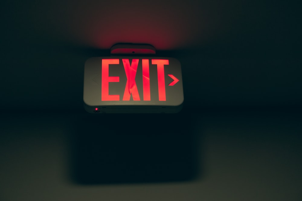 a red exit sign sitting on top of a table