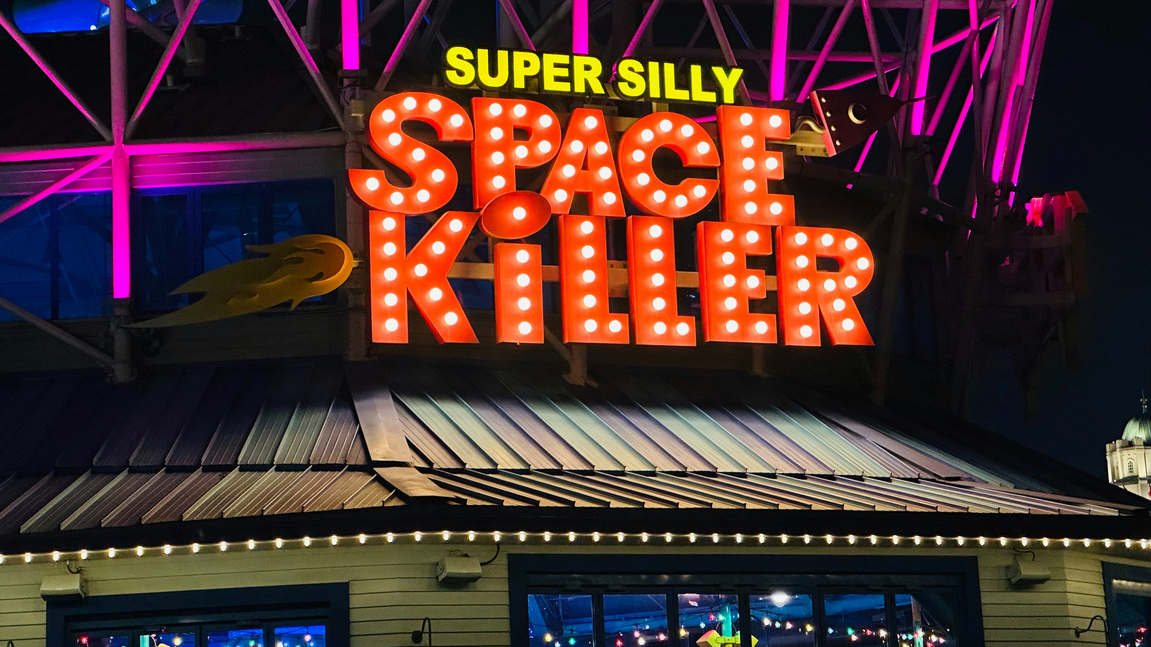 A neon sign on top of a building photo – Free City Image on Unsplash