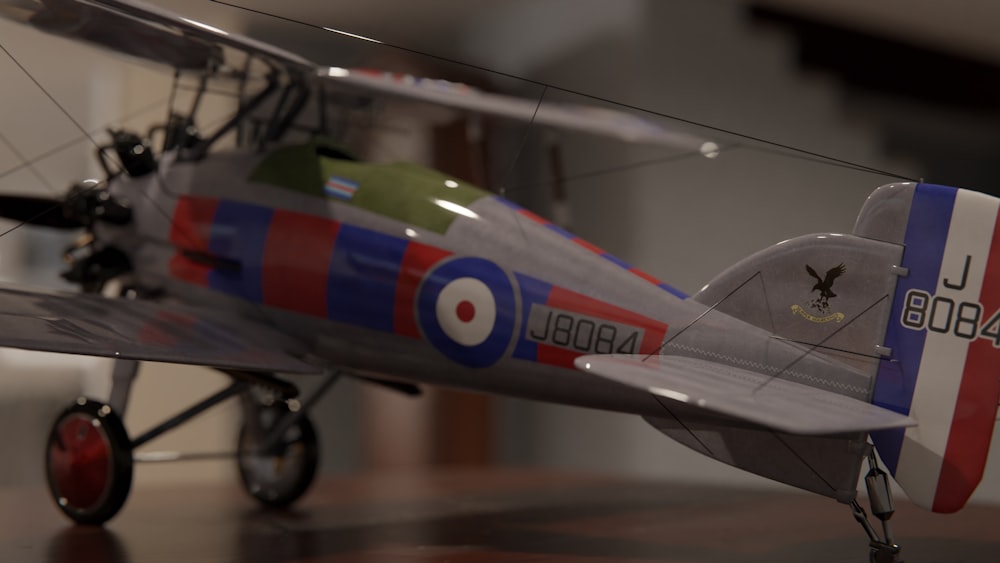 a model of a red, white, and blue airplane on a table